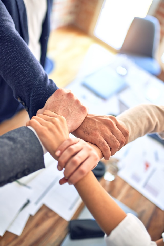 hands interlocking in office