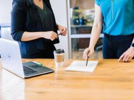 two people in an office looking over a document