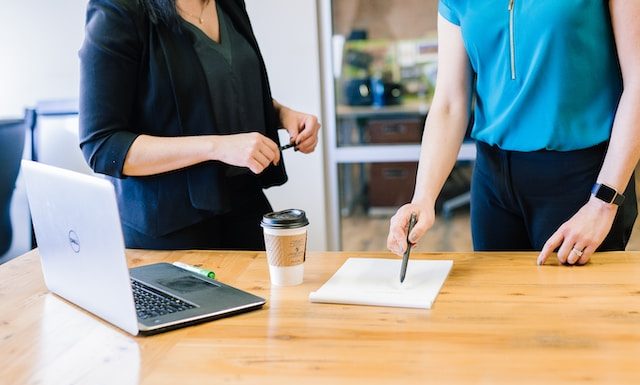 two people in an office looking over a document